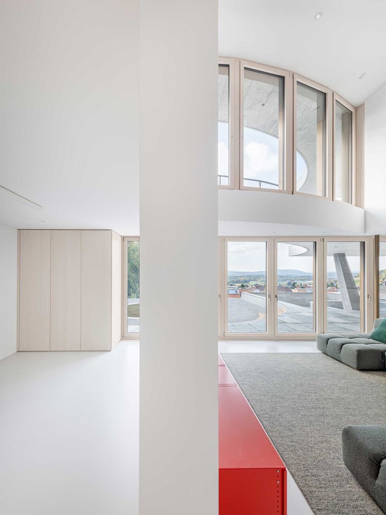 Die präzise gesetzten Fenster rahmen das Tal wie ein lebendiges Bild und machen Licht, Wetter und Jahreszeiten unmittelbar erfahrbar.
